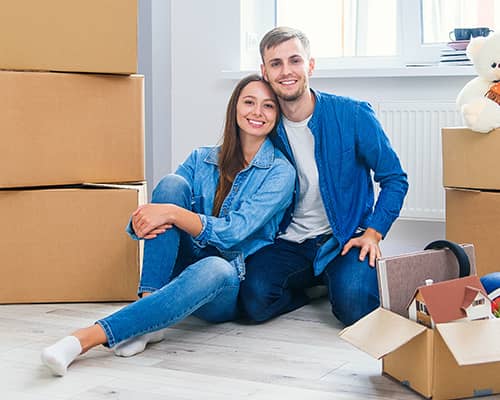 Happy couple moving to new home bought using assistance in Florida